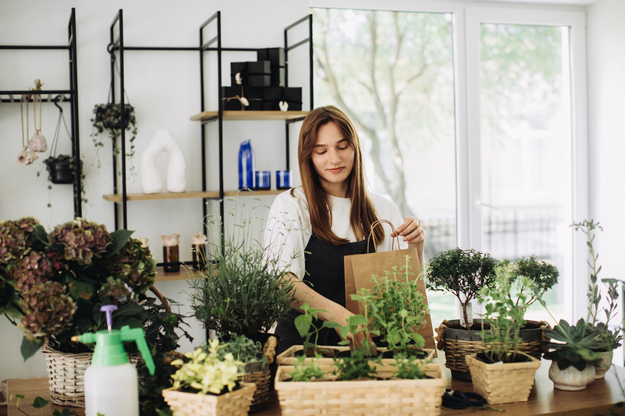 A young woman works in her flower shop. Small business concept.