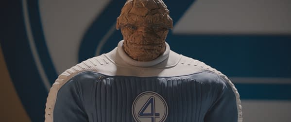 Ebon Moss-Bachrach portrays Ben Grimm, also known as The Thing, in a blue and white superhero suit featuring the number four emblem, from the Marvel Studios film 