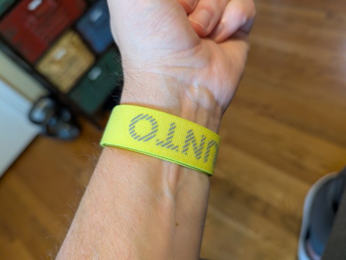 A close-up view of a wrist wearing a bright lime-colored Suunto strap, showcasing its vibrant design.