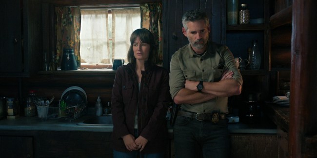 Netflix series 'Untamed' stars (L to R) Rosemarie DeWitt as Jill Bodwin, Eric Bana as Kyle Turner, shown here standing next to each other stoically in a dark kitchen