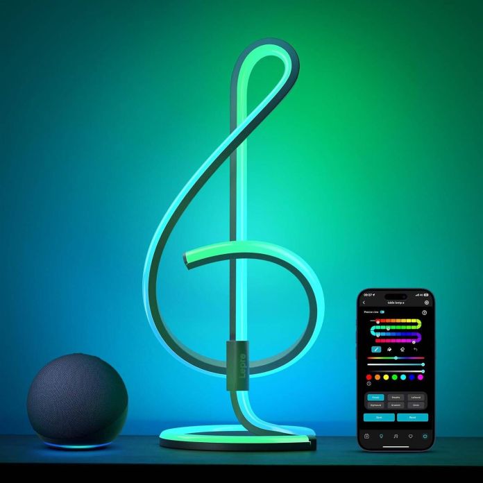 A stylish AI smart table lamp in a musical note shape, illuminated with colorful LED lights, next to a smart speaker and a smartphone displaying a lighting control app.