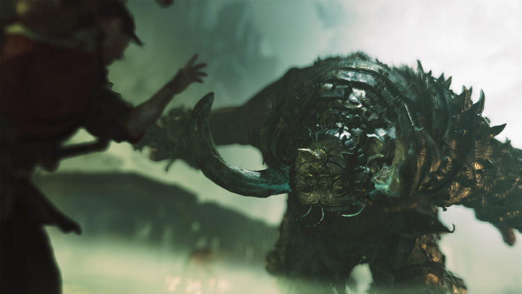 A warrior faces a massive, menacing creature in a foggy landscape