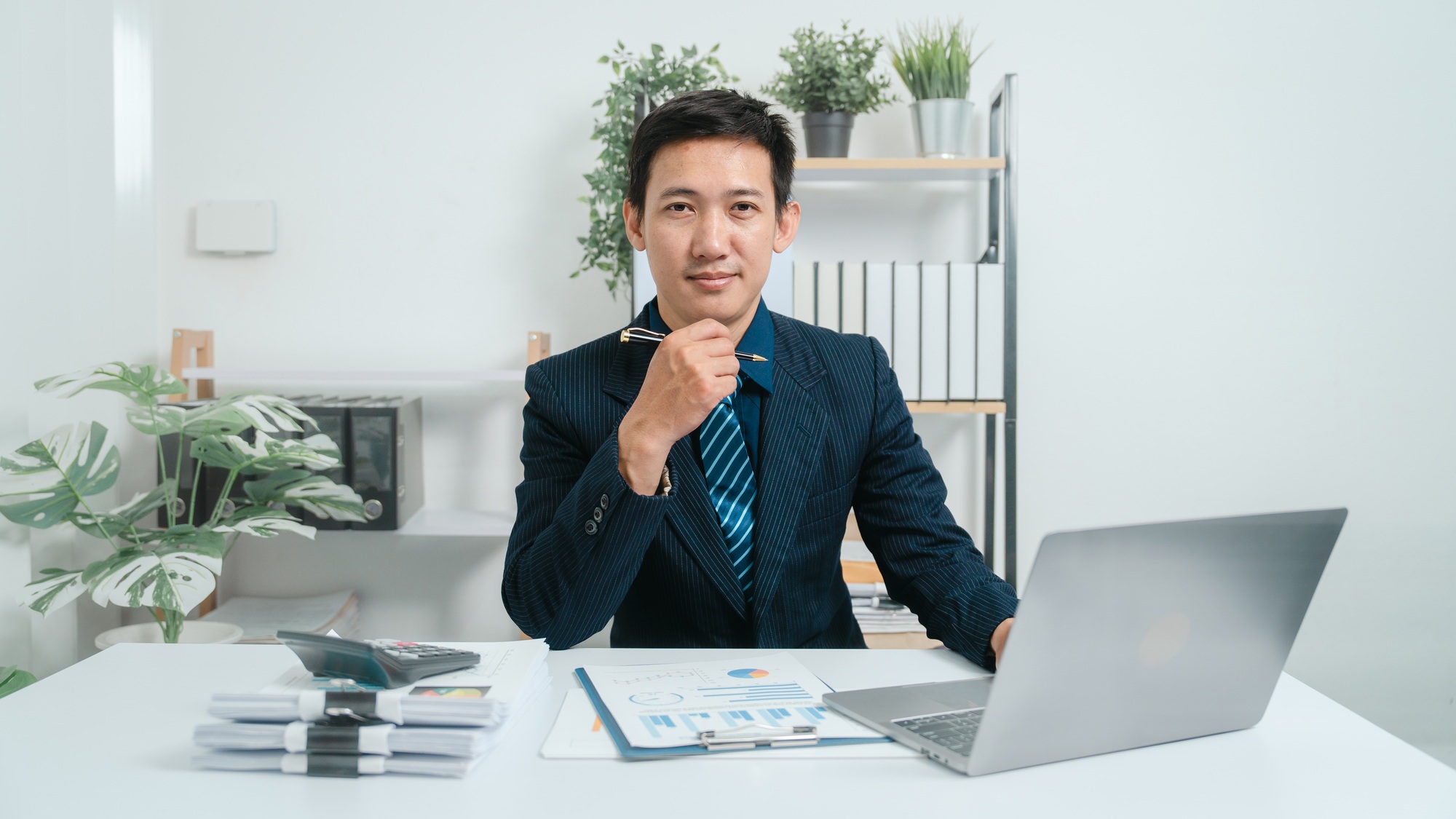Young asian business man audit analysis graph company budget report, cash inflow, pension fund