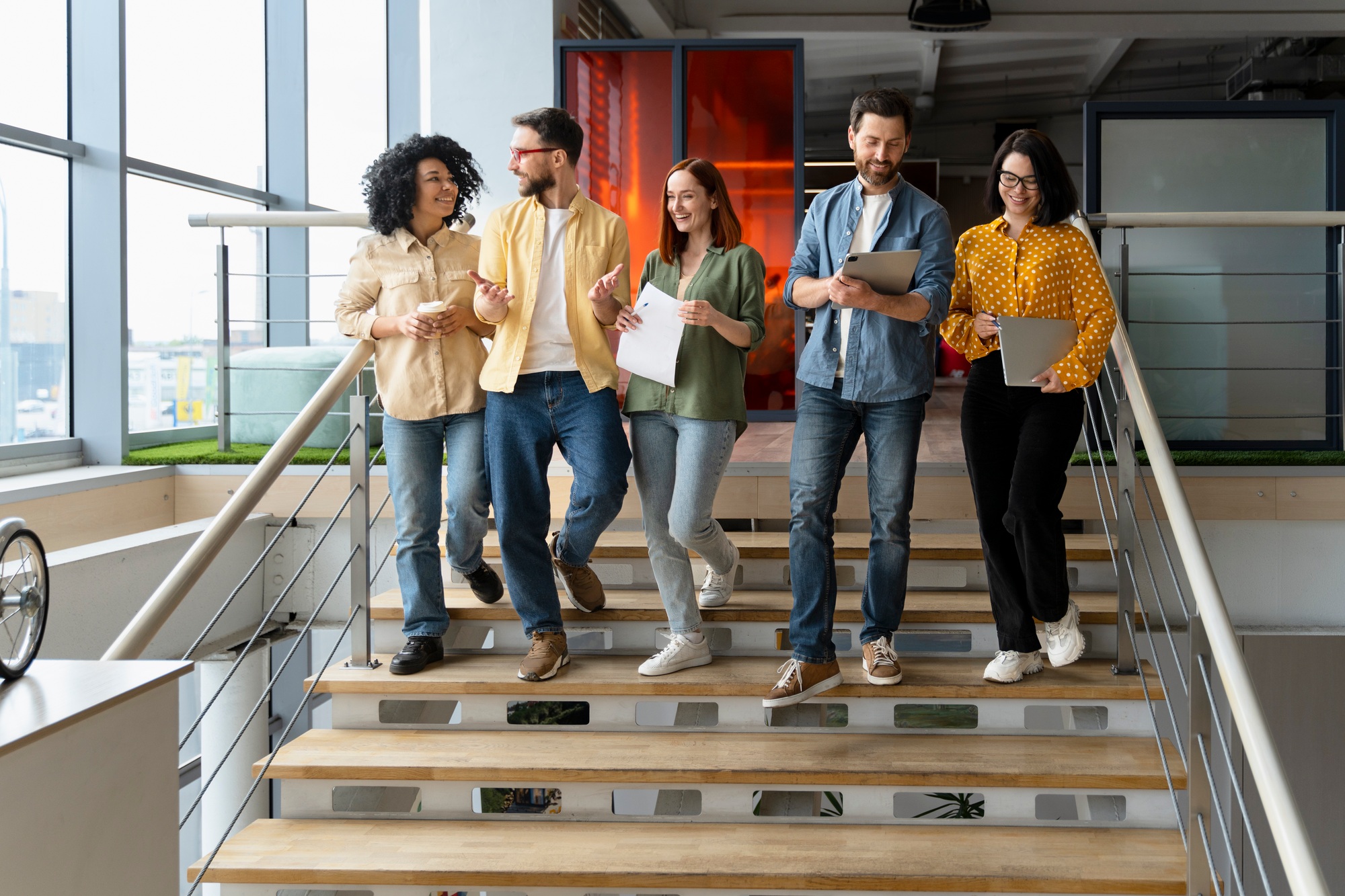 Group of successful office employees going down the stairs for a coffee break. People. Career growth