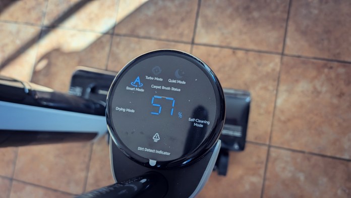 Close-up of the LED display on the Dreame H15 Pro vacuum, showing various modes including Smart Mode, Turbo Mode, and Self-Cleaning Mode.