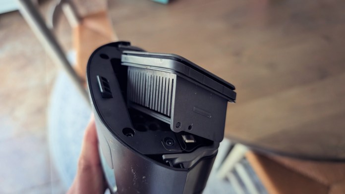 Close-up view of a wet/dry vacuum cleaner's filter compartment, showcasing its design and features.