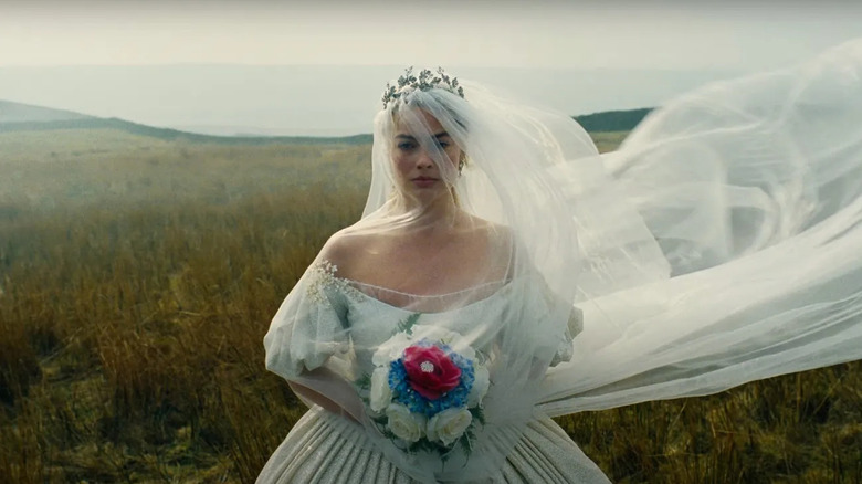 Catherine in a wedding dress with a sweeping veil in Wuthering Heights