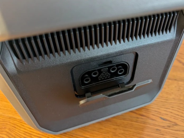 Close-up view of the back panel of a device showing a power connector and cooling vents.