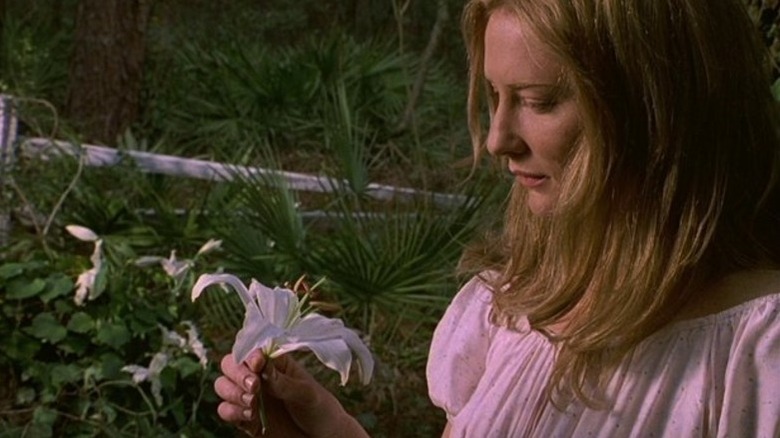 Annie looking at a flower in The Gift